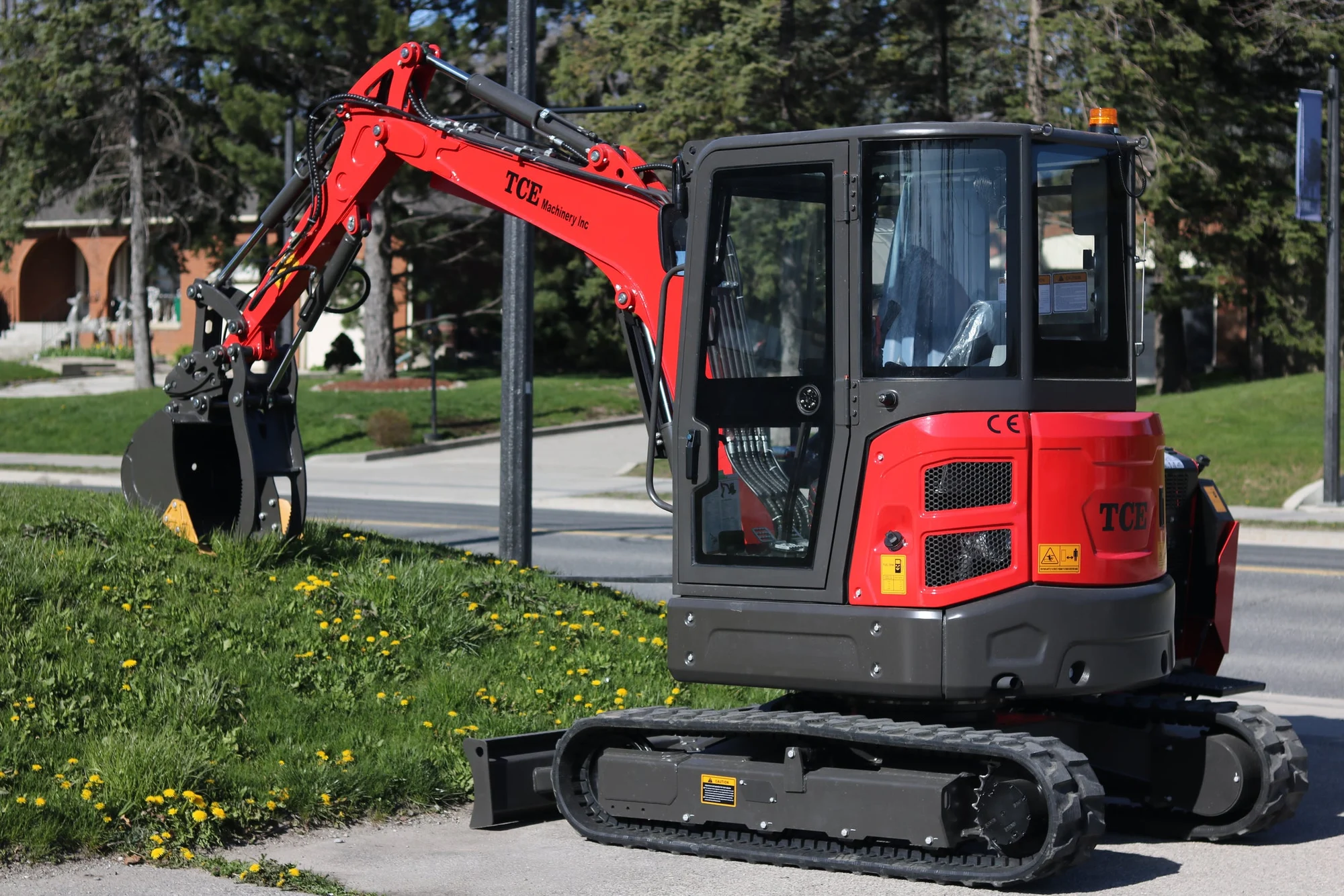 Red TCE excavator with enclosed cab outside in Ontario